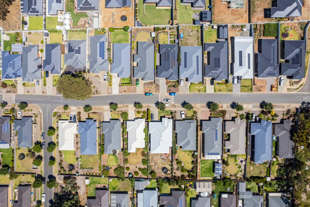 istock Aerial view new rural housing development, mostly grey roofing, some green landscaping, trees 1466578535
