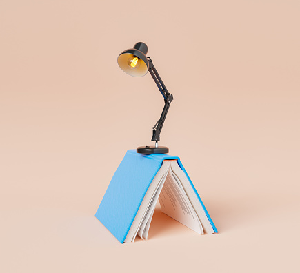 Opened book with table lamp