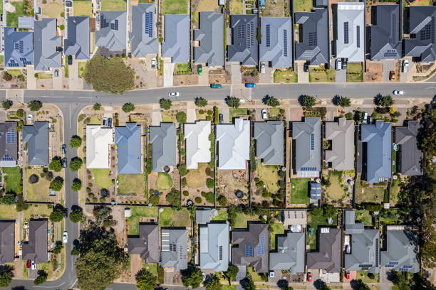 istock Aerial view new rural housing development, mostly grey roofing, some green landscaping, trees 1466585410