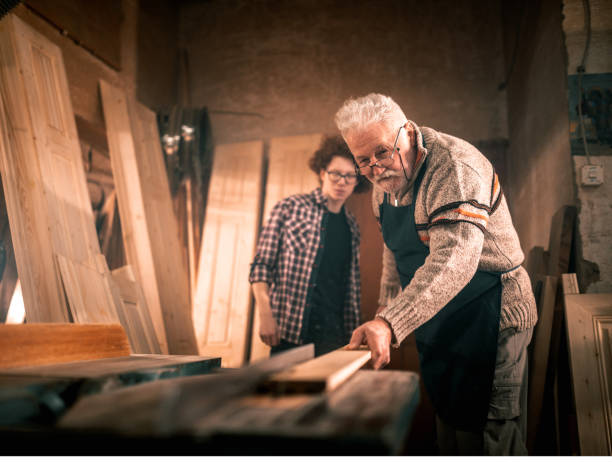 istock grandfather teaches grandson to work in carpentry workshop 1466587542