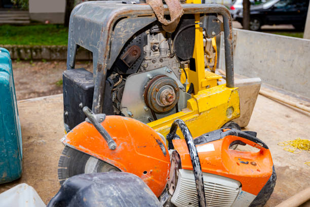istock Rammer standing soil compactor, compacting jumping jack machine and circular blade saw at building site 1466588874