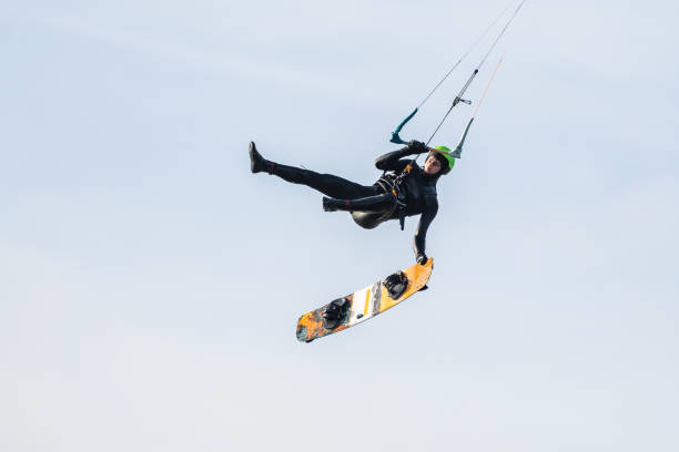 istock Kitesurfer jumping and making a board off trick in the air 1466592296