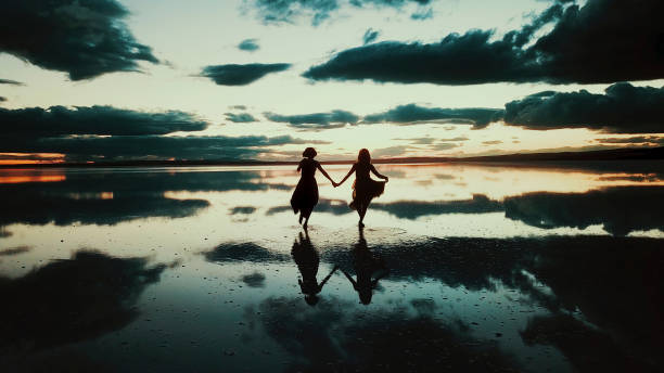 istock Young ballerinas dancing on the the sea sunset 1466593078