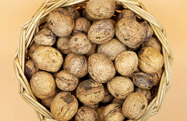 istock Top view organic shelled walnuts in wicker basket 1466594052