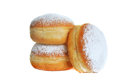 Three fresh baked doughnut isolated on white background with powdered sugar