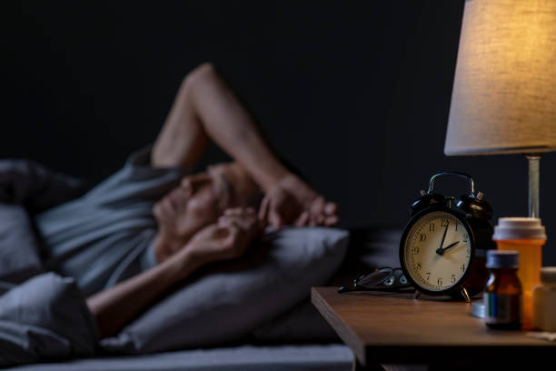 istock Depressed senior Asian man lying in bed cannot sleep from insomnia 1466596367