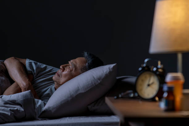 istock Depressed senior Asian man lying in bed cannot sleep from insomnia 1466597693