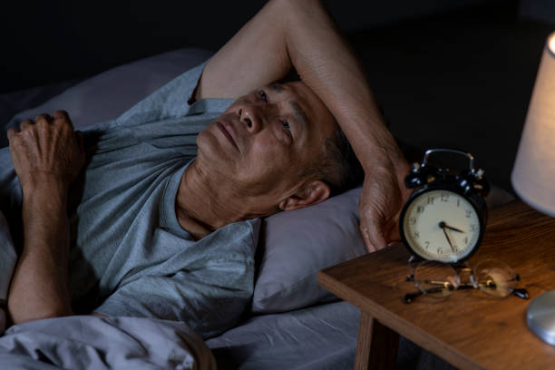 istock Depressed senior Asian man lying in bed cannot sleep from insomnia 1466597721