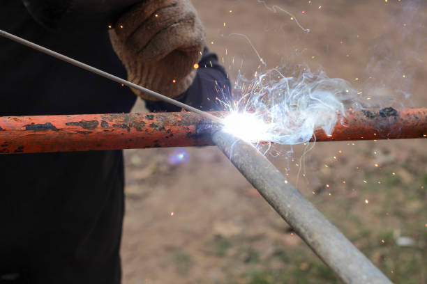 istock Smoke and sparks from welding steel. 1466599421