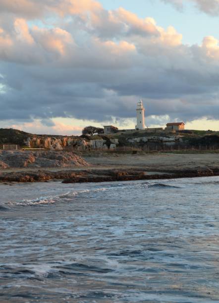istock Lighthouse at sunset on cloudy sky backgound. Pathos, Cyprus 1466600711