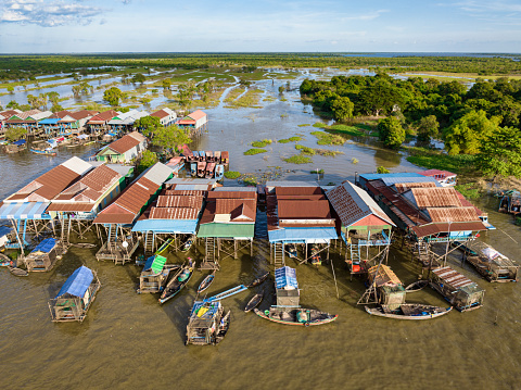 Cambodian Village of  Kampong Phluk (Harbor of the Tusks) - Floating Village Aerial Drone Point of View. Stilt Houses and Fishing Boats and Fishing Farm Houses of Kampong Phluk - the well known Floating Village near Siem Reap and Lake Tonle Sap - situated close to the watered rural rice fields. Kampong Phluk Floating Village, Siem Reap Province, Prasat Bakong, Cambodia, South East Asia, Asia.