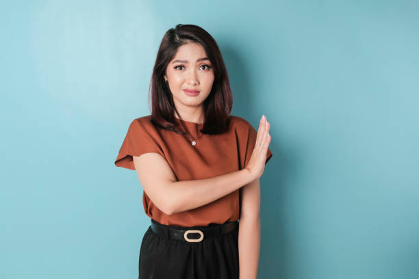 istock Beautiful Asian woman with hand gesture pose rejecting offer with copy space 1466603050