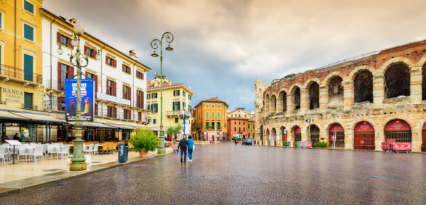VERONA, Italy - September 29, 2022: Cityscape of Verona with Piazza Bra and Arena of Verona on a summer day after a thunderstorm. Dramatic sky with clouds. Travel destination in Italy concept
