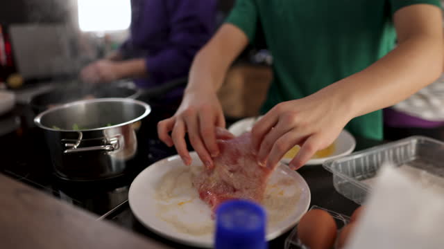 Teenagers cooking lunch for the whole family
