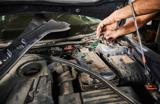 istock Enginner, mechanic holding screwdriver, repairing, fixing car. 1466607611