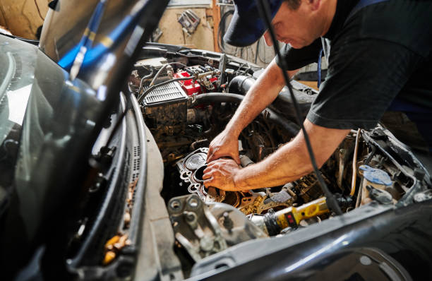 istock Worker, repairman wearing cap, repairing car engine. 1466607664