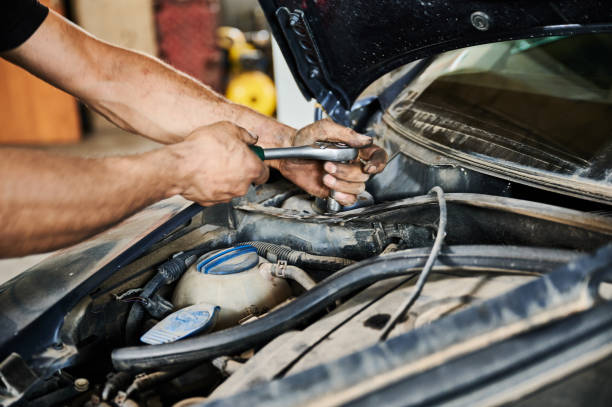 istock Enginner, mechanic holding screwdriver, repairing, fixing car. 1466607706
