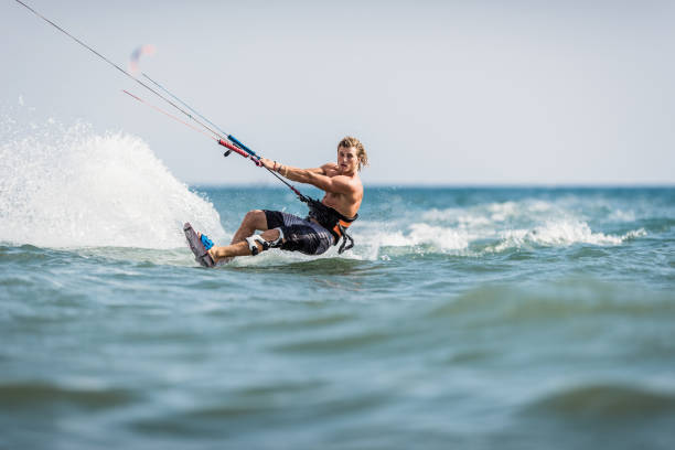istock Young man enjoying in kiteboarding during summer day at sea. 1466612015