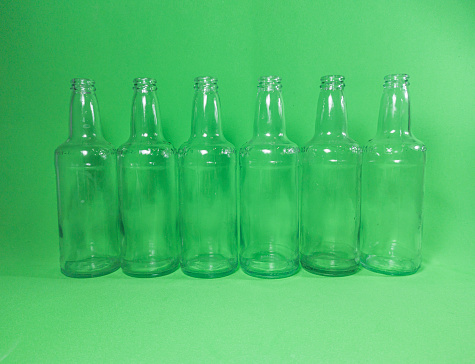 a lot of transparent bottles on a green background