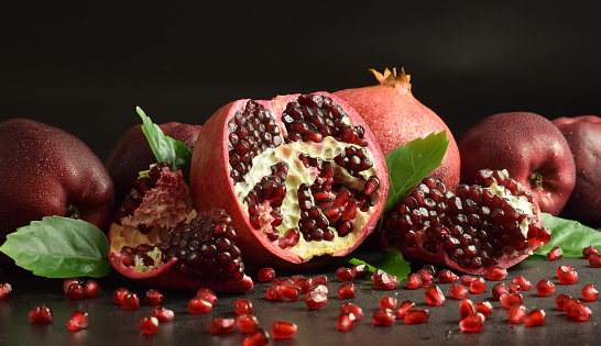 A close-up view of a basket of fresh and healthy Pomegranates (Punica granatum), a berry fruit native to south-western Asia, widespread in the Caucasus region and in Armenia, Afghanistan, Iran, Turkey, Pakistan and Malaysia and cultivated in the countries of the Mediterranean area. The traditional Mediterranean diet consists of natural, healthy and fresh products, including fruits, vegetables and grains. Image in high definition format.