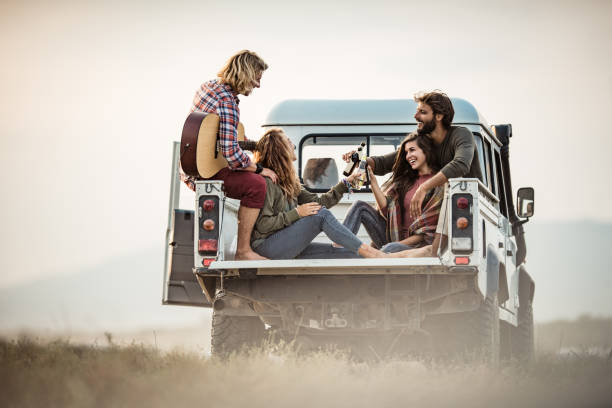 istock Young happy couples toasting in pick-up truck. 1466612773