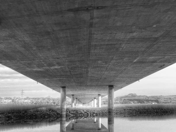 istock View of the underside of a road bridge over a river (black and white) 1466613032