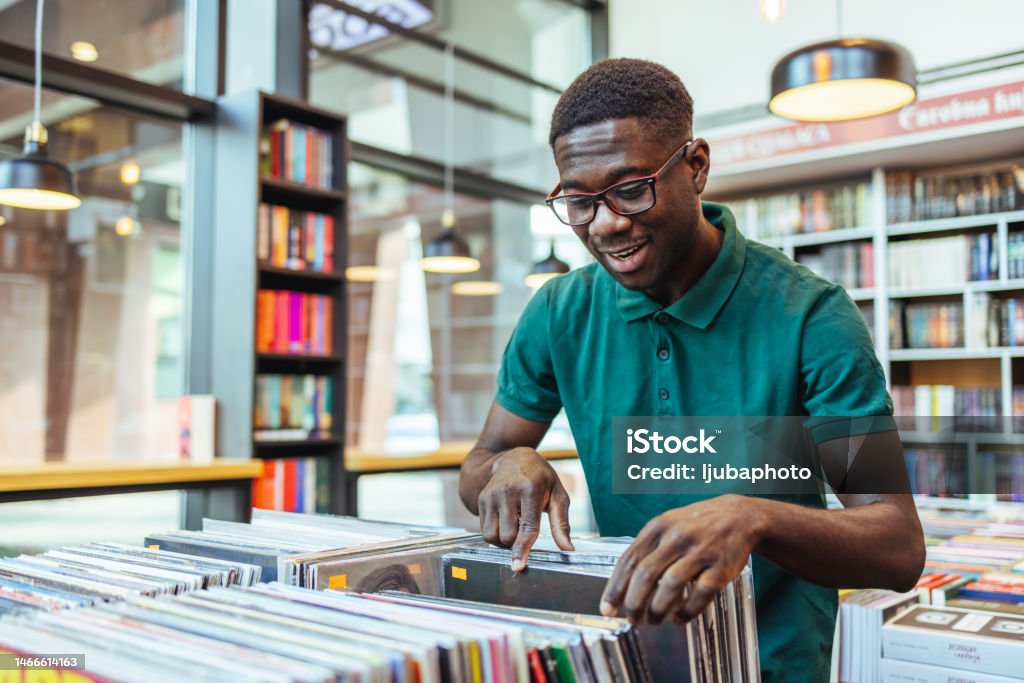 Man Shopping in a Vinyl Record Store Record - Analog Audio Stock Photo