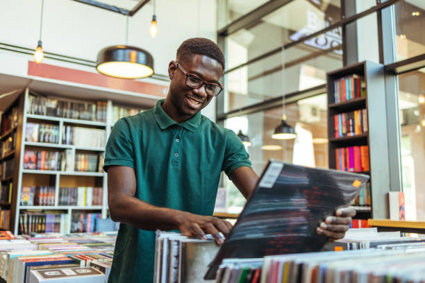 istock Man holding long playing record in the store. 1466614200