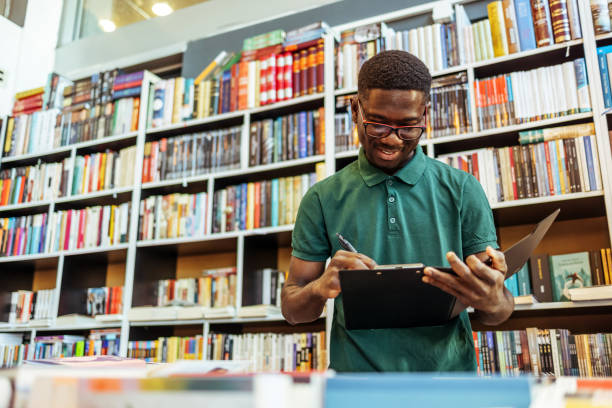 istock Focused young man studying while making use of his clipboard. 1466615180
