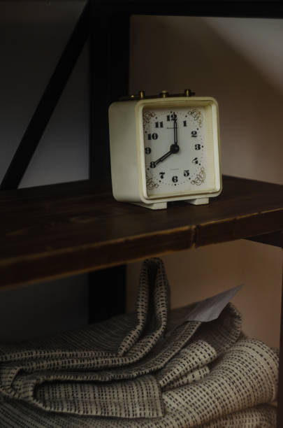 istock Closeup of an old classical clock on a wooden shelf 1466617075