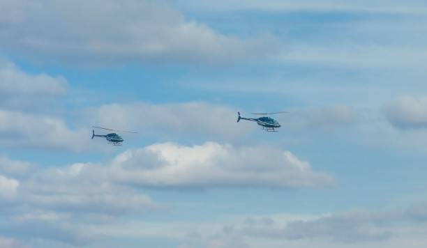 istock Helicopters flying high in the blue sky 1466617404