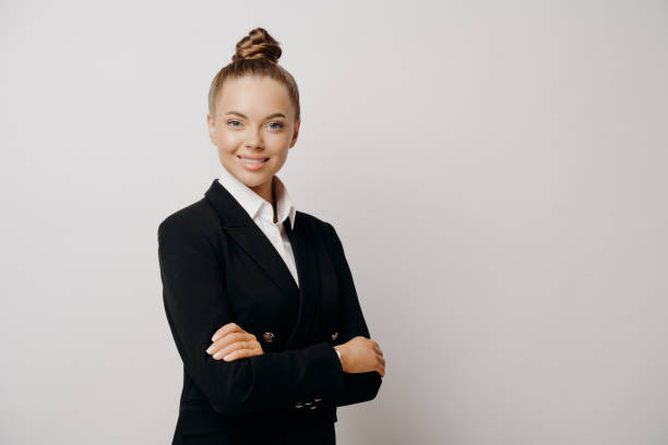 istock Woman executive in dark suit standing sideways 1466619793