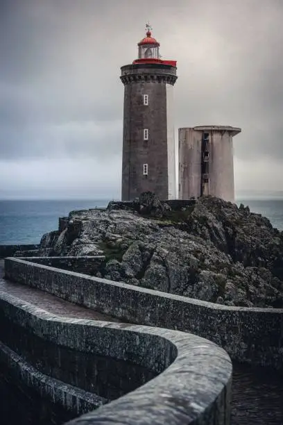 A vertical shot of the Petit Minou Lighthouse under the clouded sky in Plouzane, France