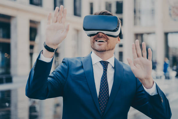 istock Office worker in formal suit exploring virtual world with VR glasses while relaxing outdoors 1466620765