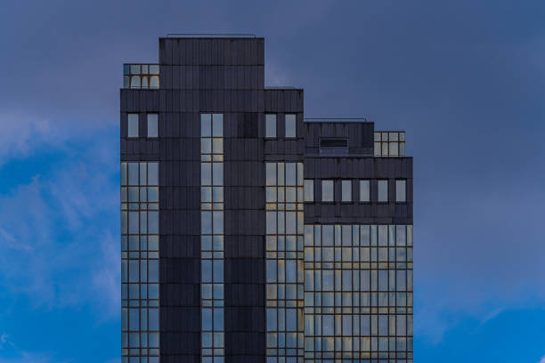 istock Tranquil view of a futuristic skyscraper with glass windows on a cloudy sky 1466622690