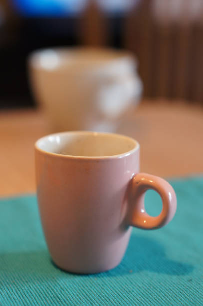 istock Vertical shot of a pink mug on a blue tablecloth 1466624142