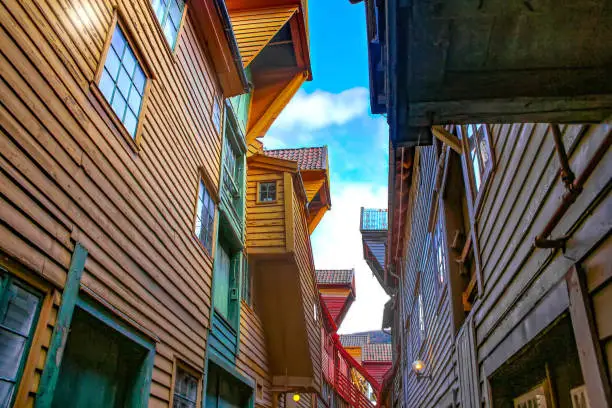 Alley way inbetween the historic colourful wood buildings of Bryggen, the old wharf of Bergen which is a UNESCO heritage site and one of the most famous landmarks of the city. Bergen, Norway.
