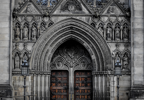 The ornate facade and doorway of St Giles' Cathedral  with Victorian architecture in  the Old Town of Edinburgh, Scotland