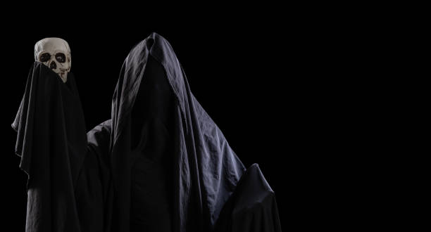 istock mysterious black man holding a skull in his hand isolated on black background 1466626995