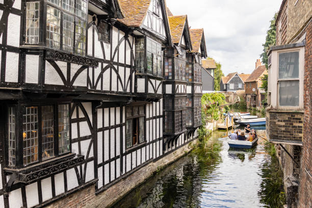 Tourist enjoying punting guided-tour in the heart of old Canterbury. Canterbury, Kent, united kingdom, 22, August 2022 Tourist enjoying punting guided-tour in the heart of old Canterbury. canterbury uk stock pictures, royalty-free photos & images