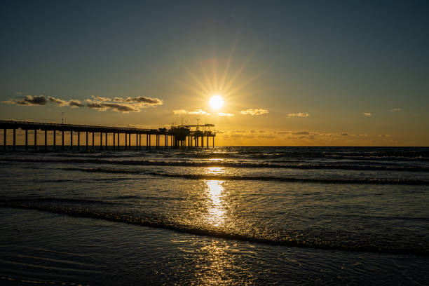 istock Silhouette of a construction platform on the beach on the sunset 1466627820