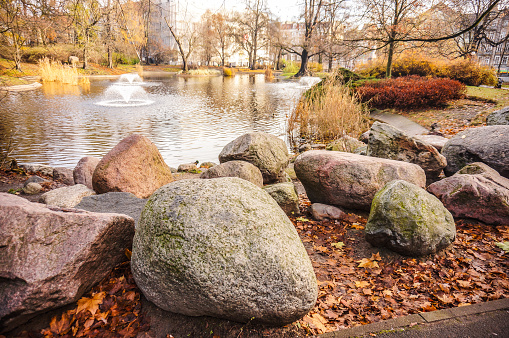 A beautiful view of the rocks surrounding the pond in the park