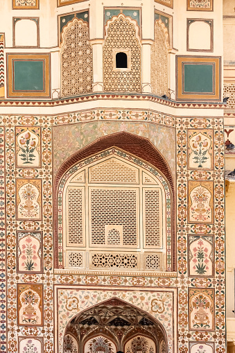 The ornate carvings on the arches and entrance walls to the ancient Amer fort in the city of Jaipur in Rajasthan, India.