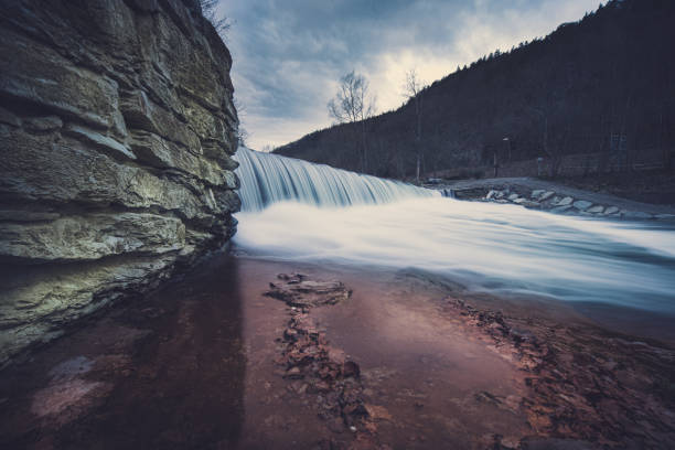 istock Beautiful view of a small waterfall under a cloudy sky 1466630131