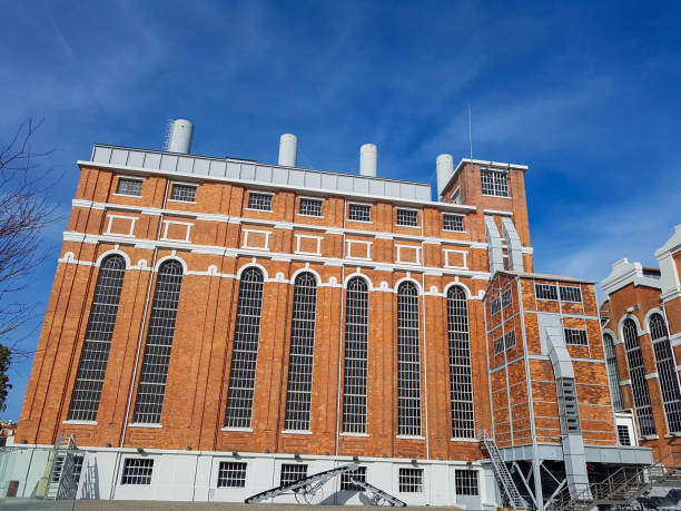 istock Low angle shot of a brick building with chimneys under a bright sky 1466632042