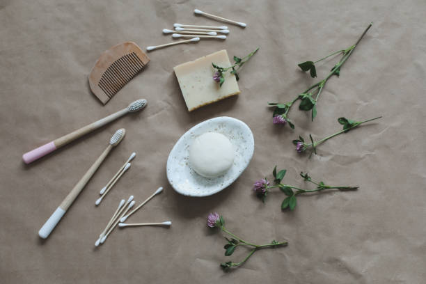 istock Soap bar or solid shampoo on a soap dish, bamboo toothbrush and towel top view with copyspace. Accessories for personal hygiene. Plastic free and eco friendly products in household 1466632391