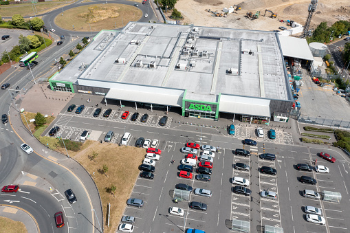 Leeds UK, 14th July 2022: Aerial photo of the Asda Supermarket, taken with a drone on a sunny summers day showing the supermarket and car park