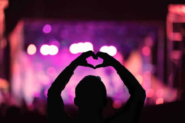 Silhouette of a man with concert stage lights