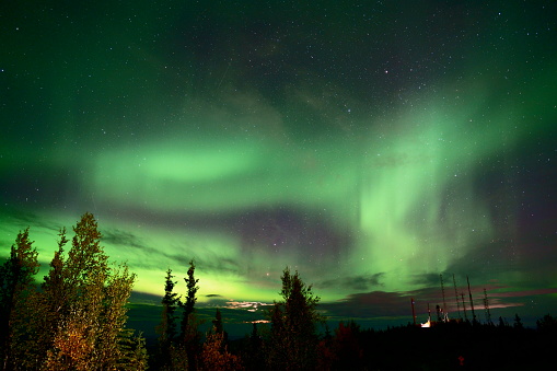 A natural light display of aurora with dynamic patterns of brilliant lights