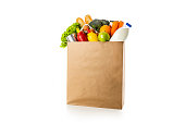 Shopping bag full of groceries on white background